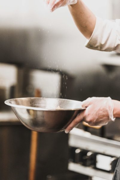 chef holding a bowl with flour