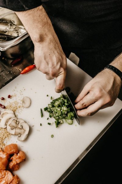 chef chopping vegetables in kitchen